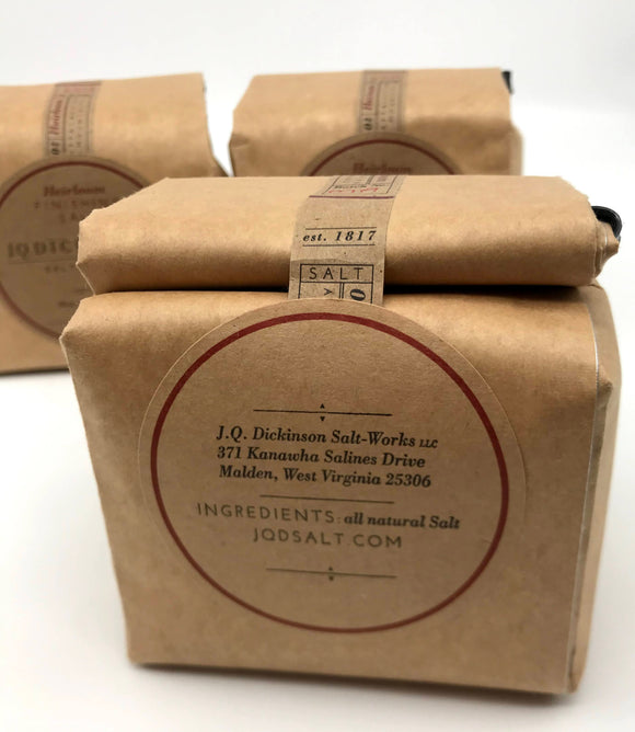 A small, sealed brown paper bag with a label that shows ingredients. All natural salt.