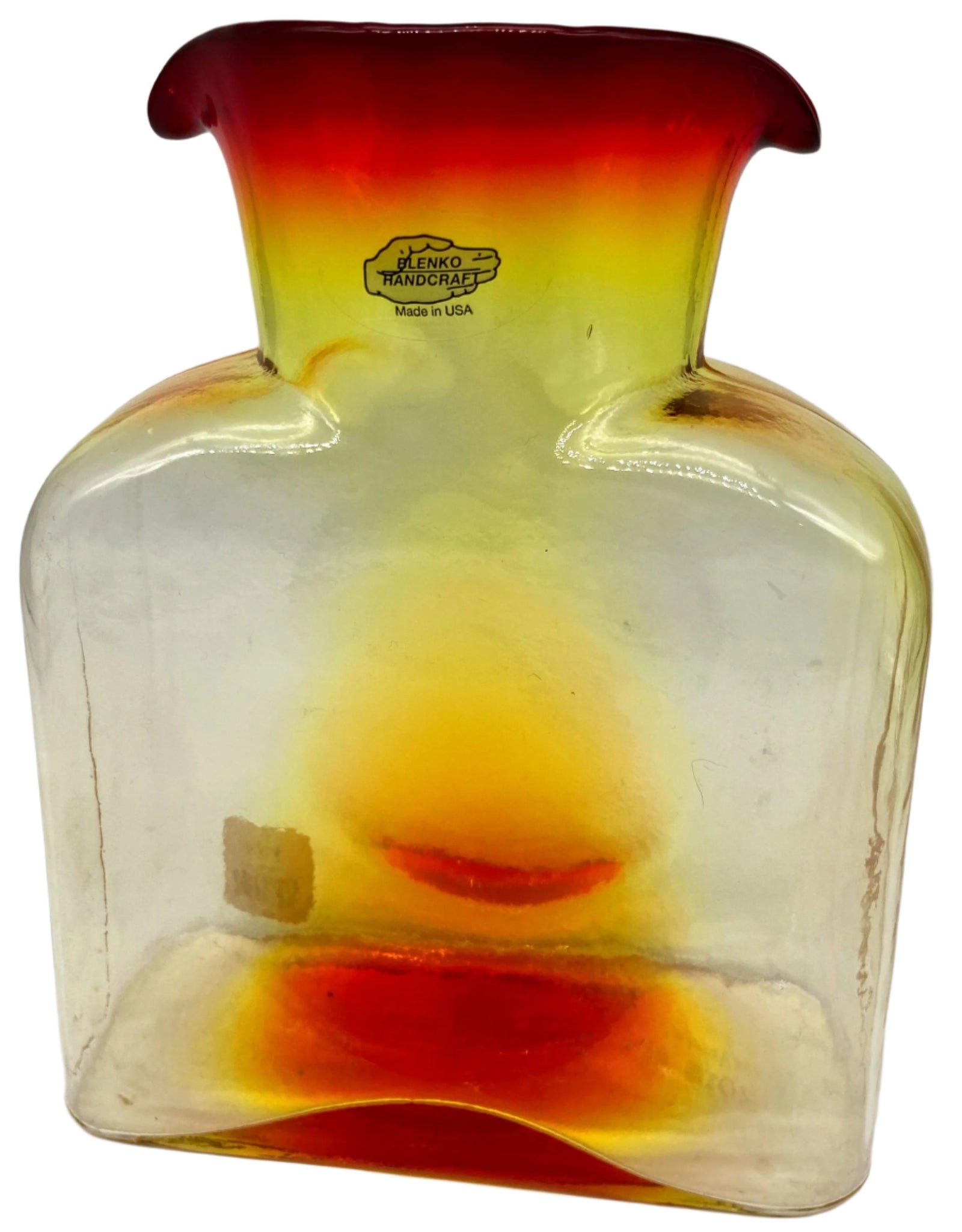 A tangerine colored glass water bottle.
