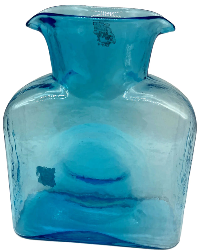 An ice blue glass water bottle.