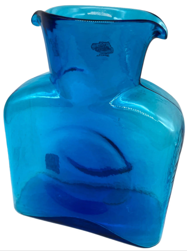A turquoise glass water bottle.