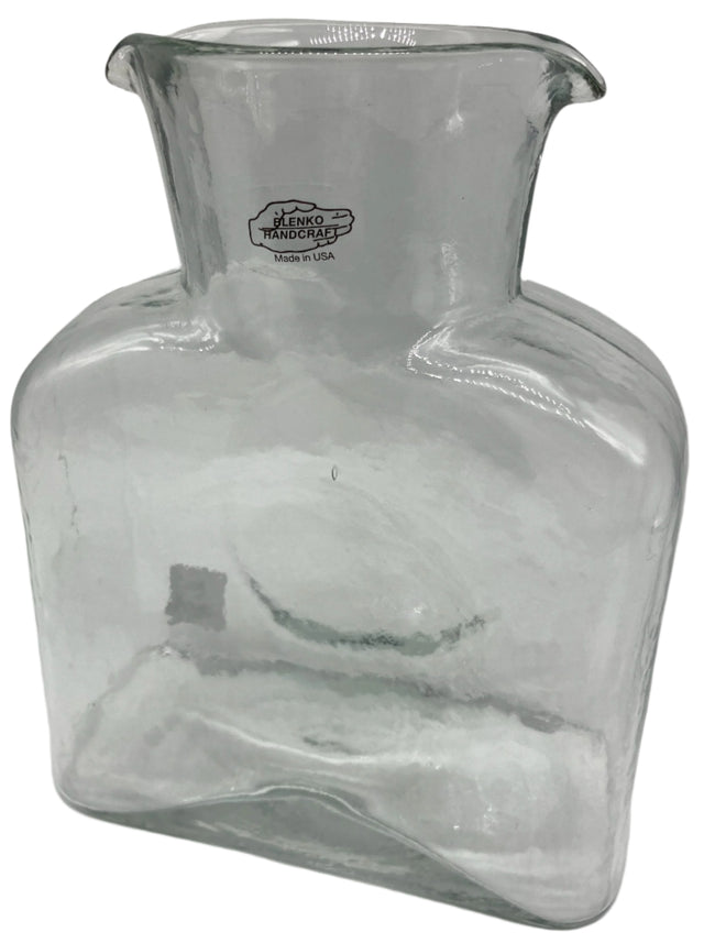 A crystal clear glass water bottle.