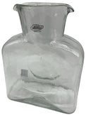 A crystal clear glass water bottle.